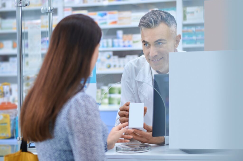 Female client standing near the pharmacy counter